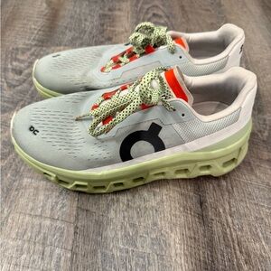 On Running Gray Shoes with Lime and Orange Accents